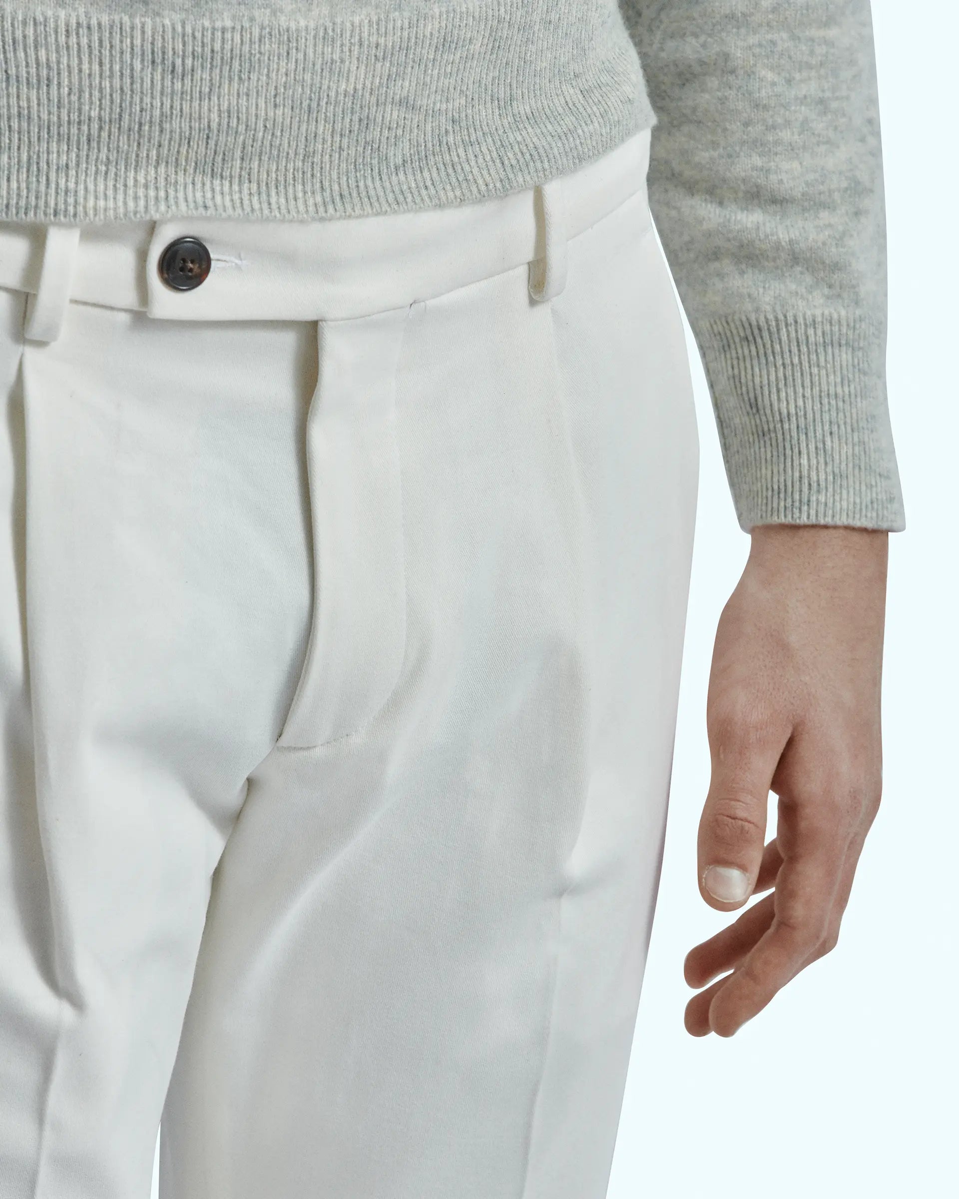 White trousers in stretch gabardine with pleats and side button placket