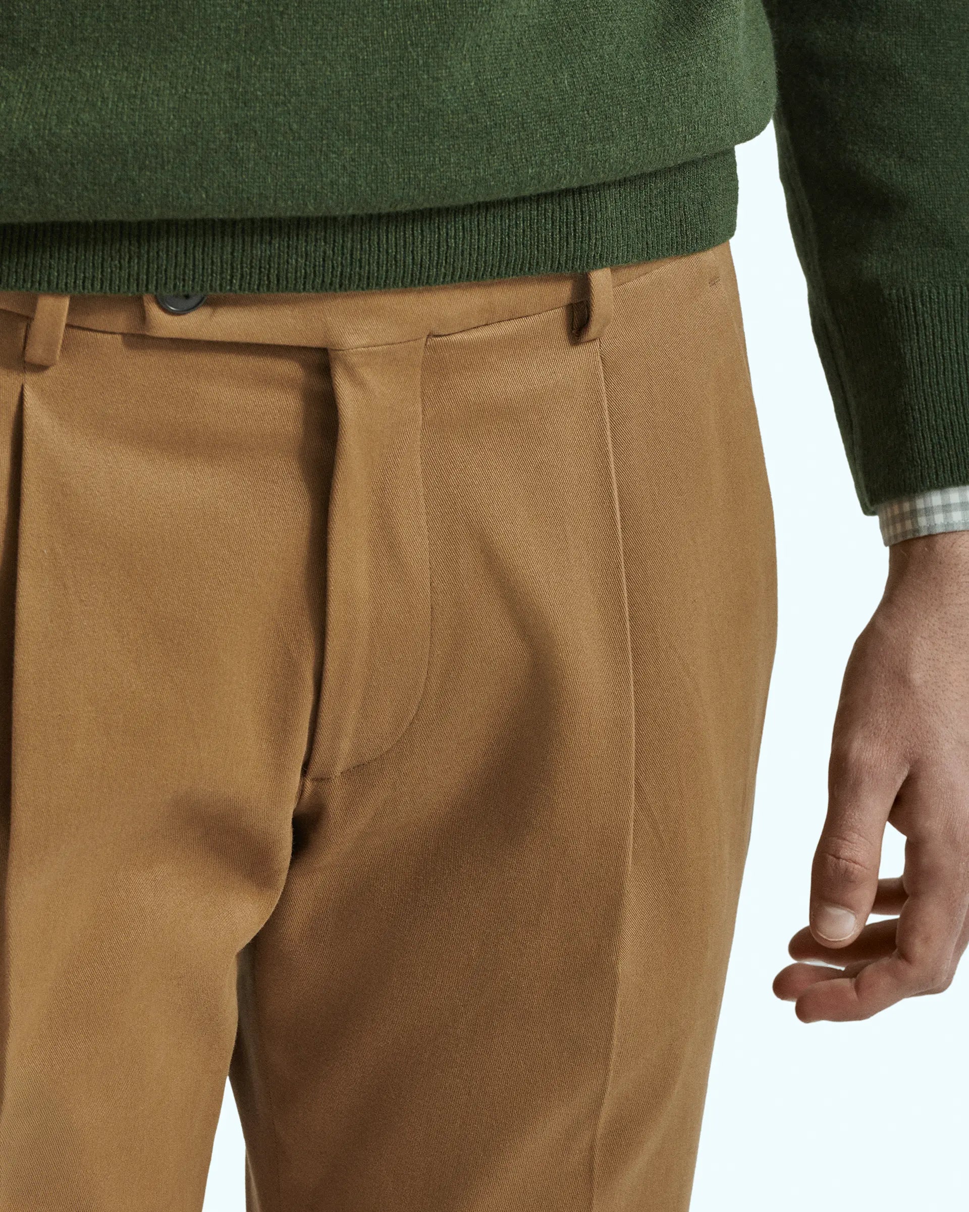 Brown trousers in stretch gabardine with pleats and side button placket