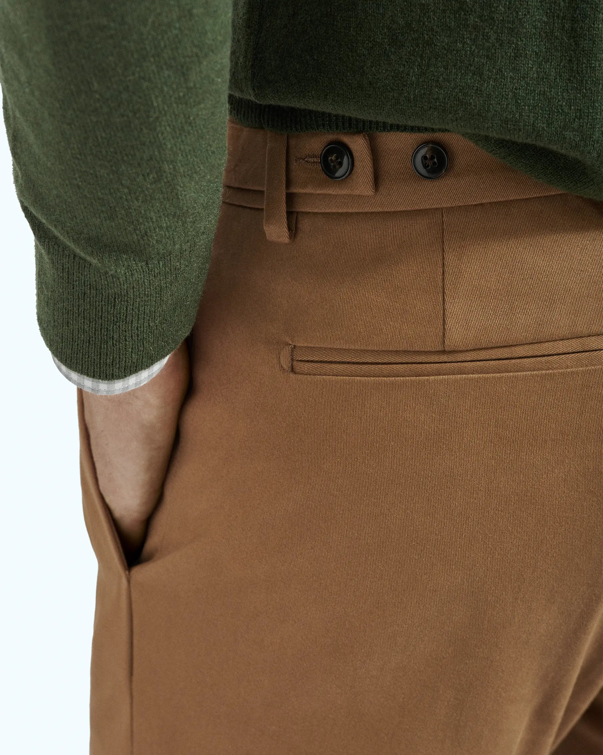 Brown trousers in stretch gabardine with pleats and side button placket